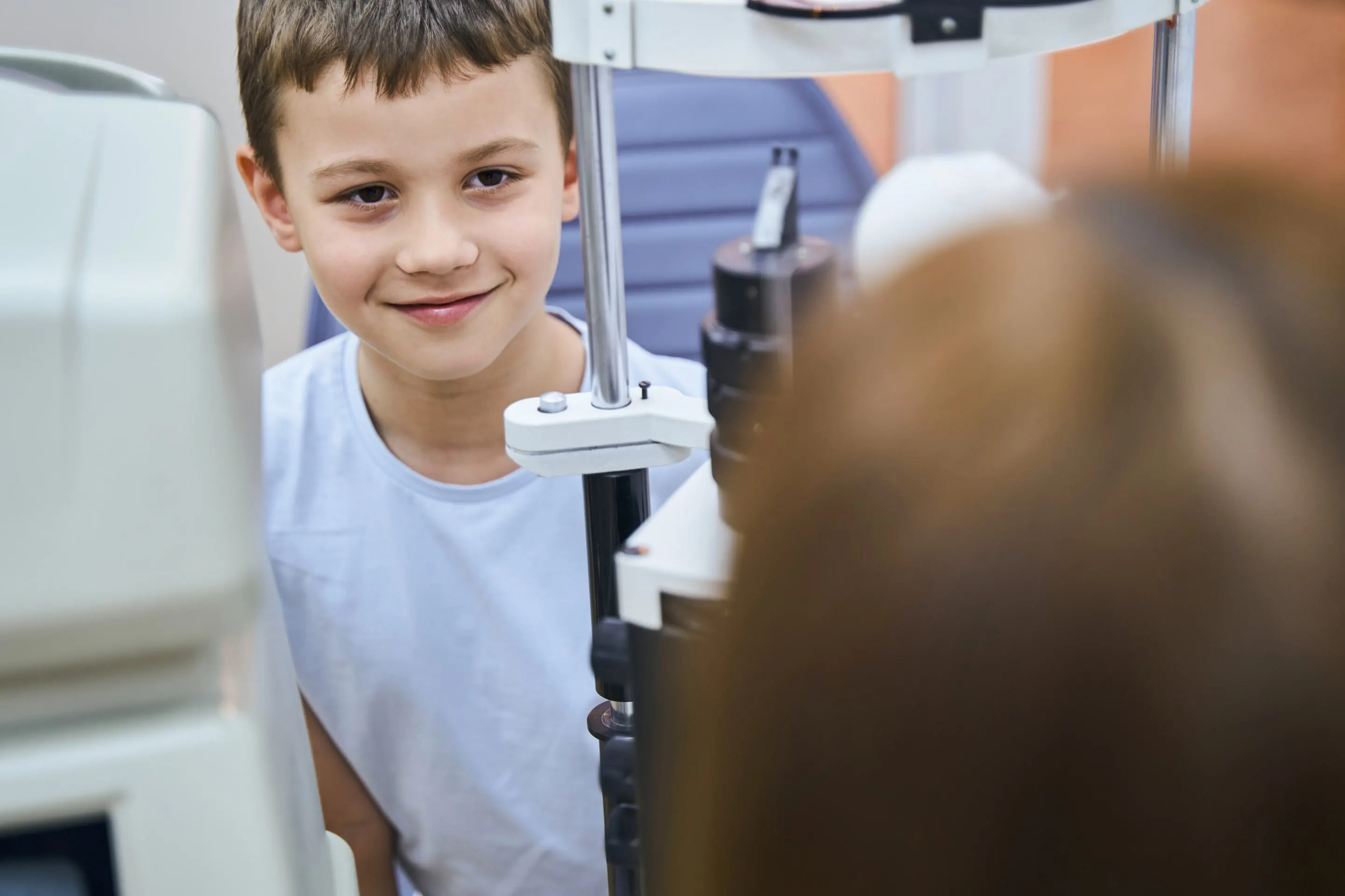 A young boy having his eyes examined